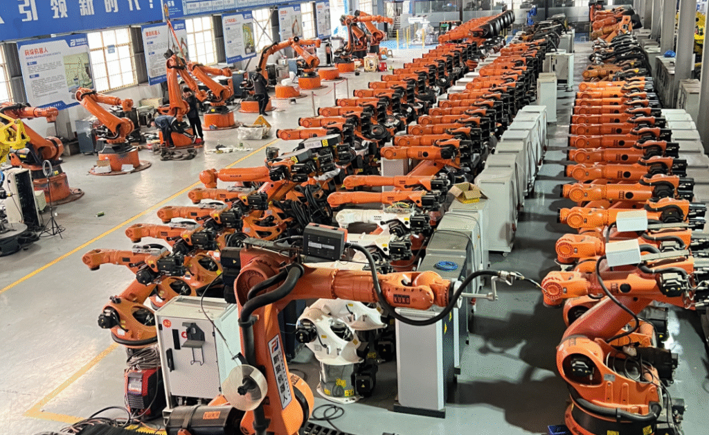 Robot welding cell loading station showing fixture and clamp arrangement